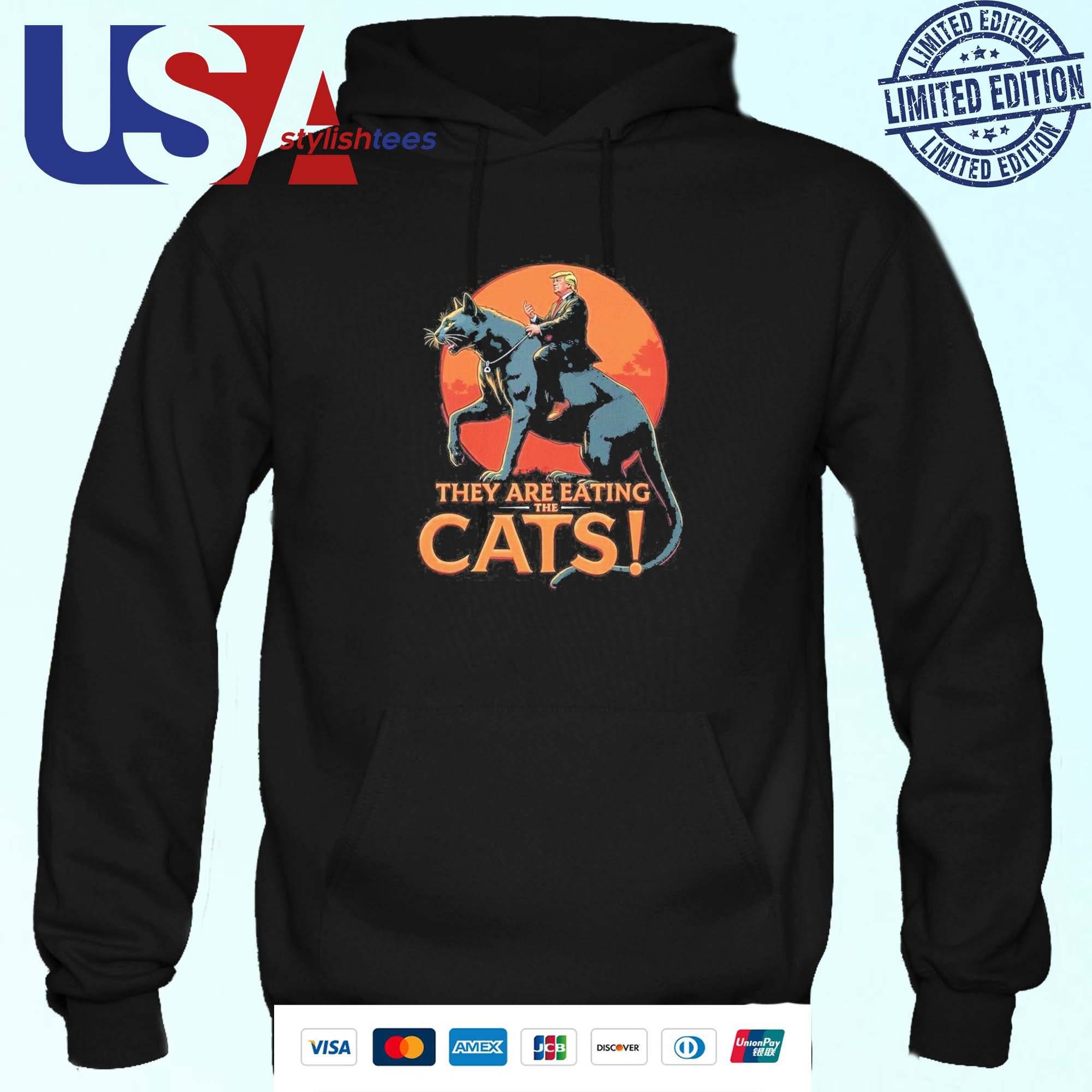 donald-trump-they-are-eating-the-cats-funny-meme-trump-riding-cat-hoodie Donald Trump Feline Consumption Humorous Meme Trump atop Cat Hoodie